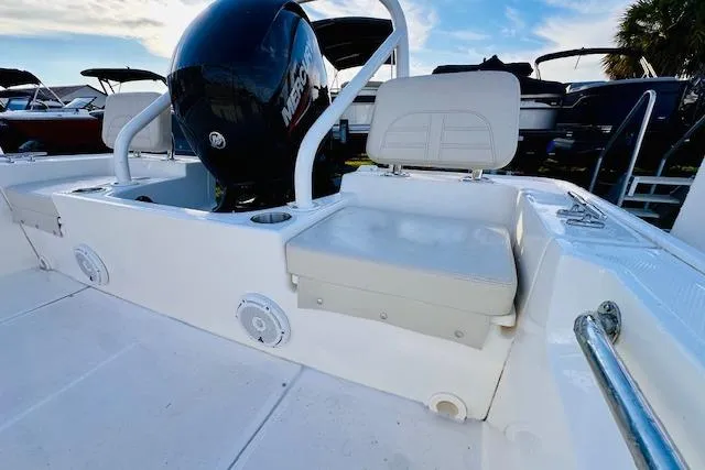 Slide: The Image of 2025 Boston Whaler 190 Montauk boat interior with seating and Mercury engine. - 14