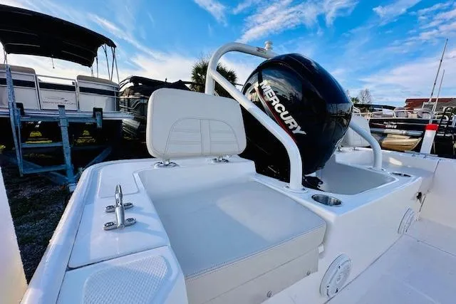 Slide: The Image of 2025 Boston Whaler 190 Montauk boat with Mercury engine, white seating, and clear blue sky. - 17