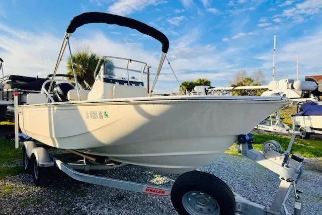 Slide: The Image of 2025 Boston Whaler 190 Montauk boat on trailer, sunny day, blue sky background. - 5