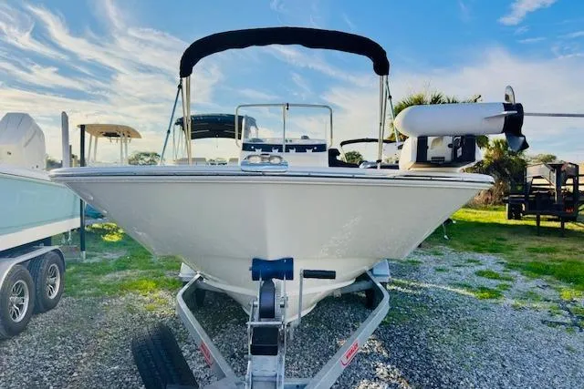 Slide: The Image of 2025 Boston Whaler 190 Montauk boat on trailer, sunny day, blue sky background. - 6