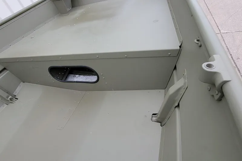 Slide: The Image of 2025 Lowe L1648M Aura Jon boat interior, showcasing storage compartment and seating area. - 10