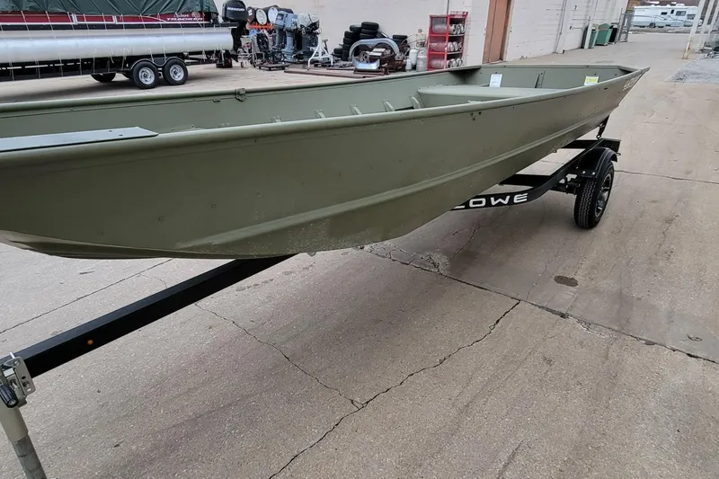 Slide: The Image of 2025 Lowe L1648M Aura Jon boat on trailer, displayed outdoors. - 3