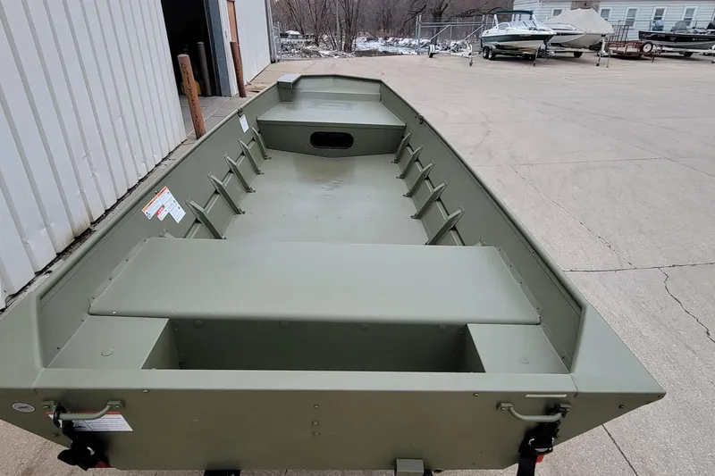 Slide: The Image of 2025 Lowe L1648M Aura Jon boat, olive green, parked outdoors near other boats. - 6