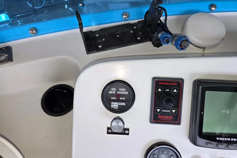 Slide: The Image of Control panel of a 2001 Commander Flybridge Sedan boat with various instruments and switches. - 18