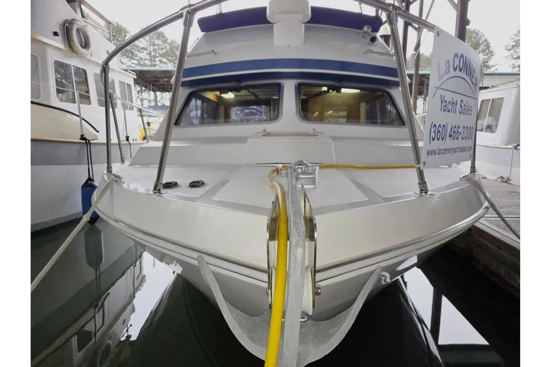 Slide: The Image of 2001 Commander Flybridge Sedan yacht docked at marina, front view. - 2