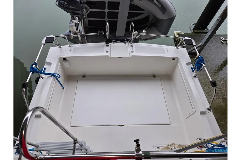 Slide: The Image of 2001 Commander Flybridge Sedan boat stern with motor and railing, docked at marina. - 29