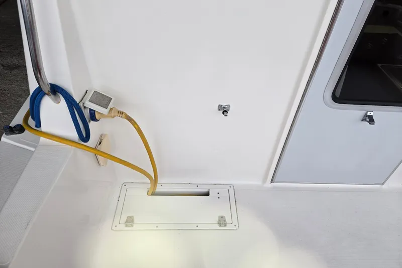 Slide: The Image of 2001 Commander Flybridge Sedan boat deck with power cables and hatch. - 36