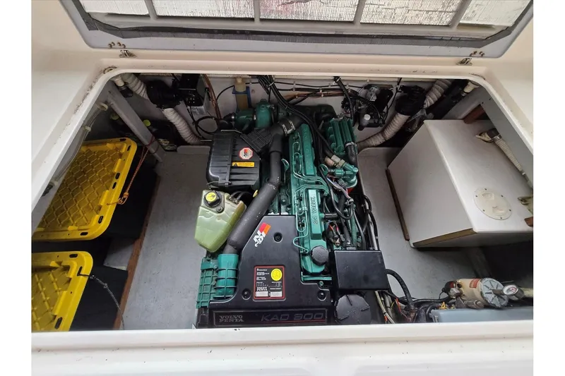 Slide: The Image of Engine compartment of a 2001 Commander Flybridge Sedan boat, featuring a Volvo Penta engine. - 38