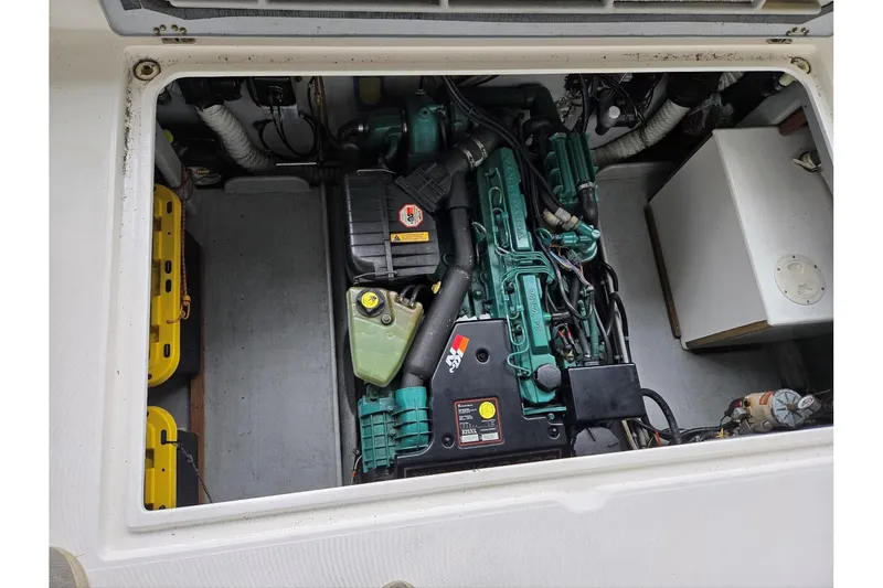 Slide: The Image of Engine compartment of a 2001 Commander Flybridge Sedan boat, showcasing mechanical components. - 39