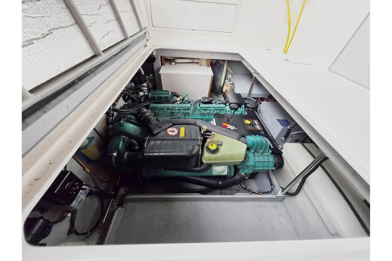 Slide: The Image of Engine compartment of 2001 Commander Flybridge Sedan boat, showcasing detailed machinery. - 40