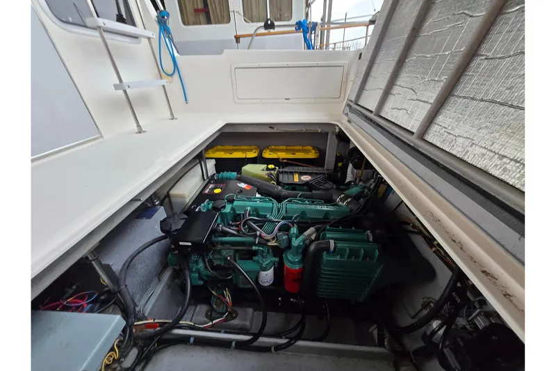 Slide: The Image of Engine compartment of a 2001 Commander Flybridge Sedan boat, showcasing mechanical components. - 43