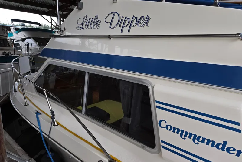 Slide: The Image of 2001 Commander Flybridge Sedan boat named "Little Dipper" docked in a marina. - 5