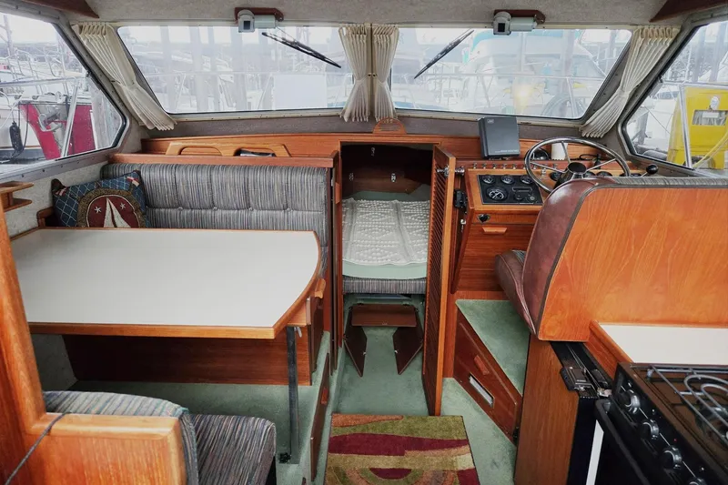 Slide: The Image of Interior of a 2001 Commander Flybridge Sedan boat with dining area and helm. - 50