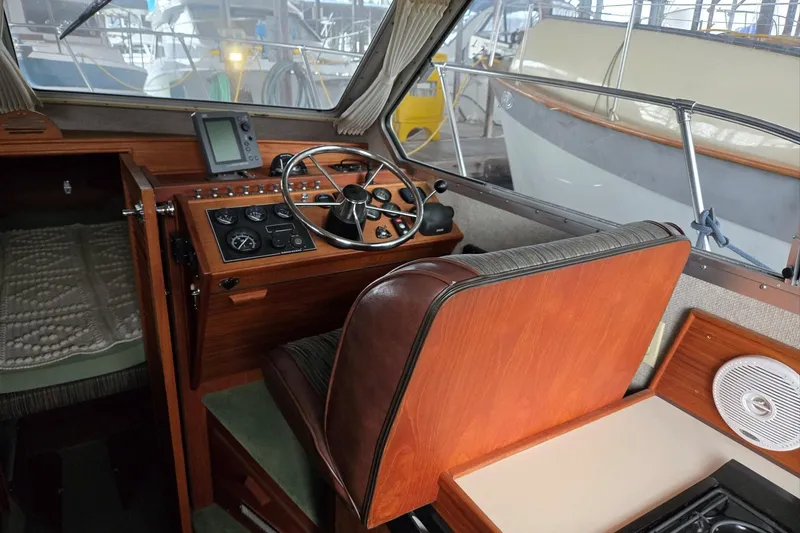 Slide: The Image of 2001 Commander Flybridge Sedan boat interior with steering wheel and control panel. - 53