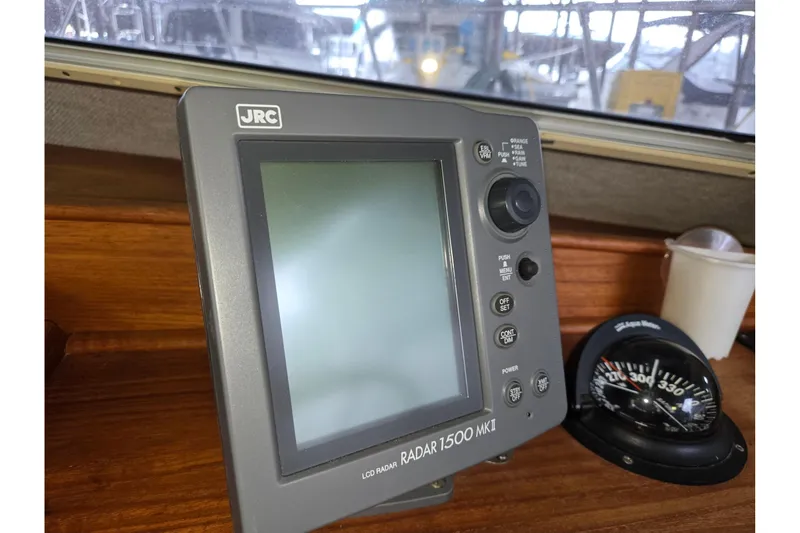 Slide: The Image of JRC LCD Radar 1500 MKII on 2001 Commander Flybridge Sedan boat dashboard. - 59
