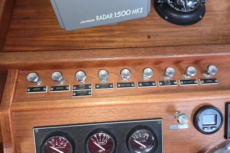 Slide: The Image of Control panel of a 2001 Commander Flybridge Sedan with radar and gauges. - 63