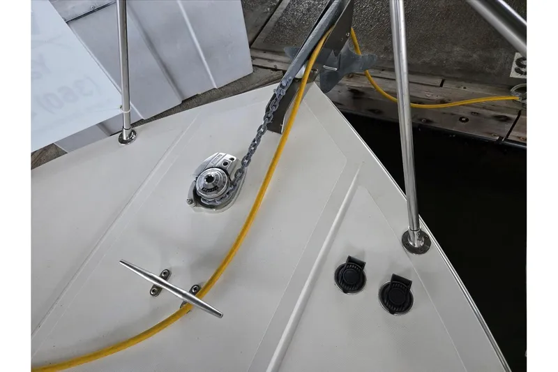 Slide: The Image of 2001 Commander Flybridge Sedan boat deck with anchor chain and yellow cable. - 8