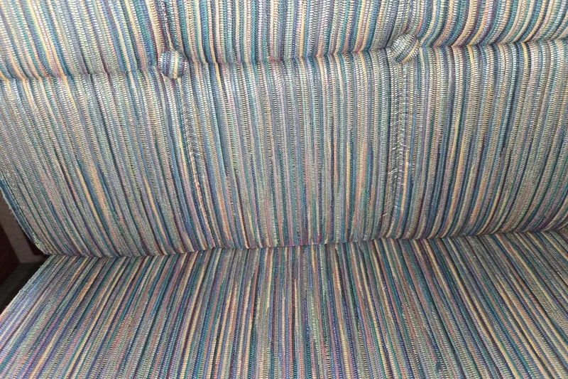 Slide: The Image of Striped upholstery on a 2001 Commander Flybridge Sedan boat seat. - 82