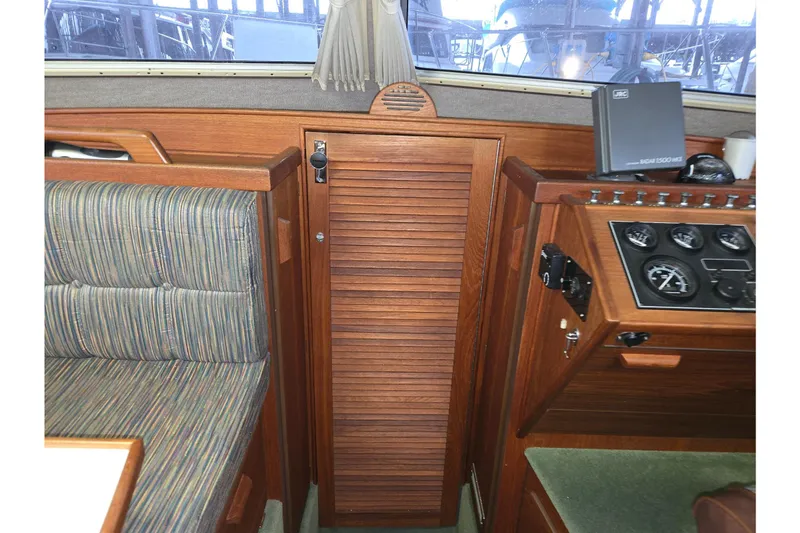 Slide: The Image of 2001 Commander Flybridge Sedan interior with wood paneling and control gauges. - 86