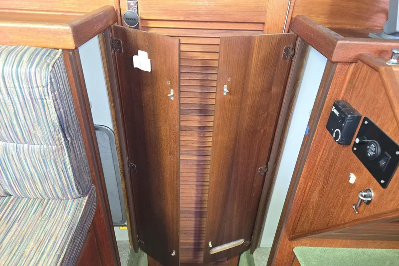 Slide: The Image of Interior of a 2001 Commander Flybridge Sedan with wooden cabinetry and striped upholstery. - 87