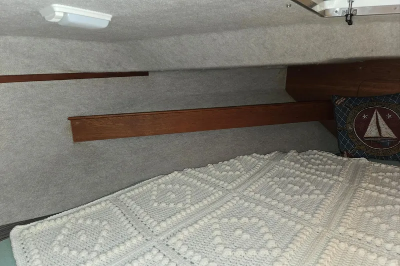 Slide: The Image of Interior cabin of 2001 Commander Flybridge Sedan with crochet blanket and nautical pillow. - 89