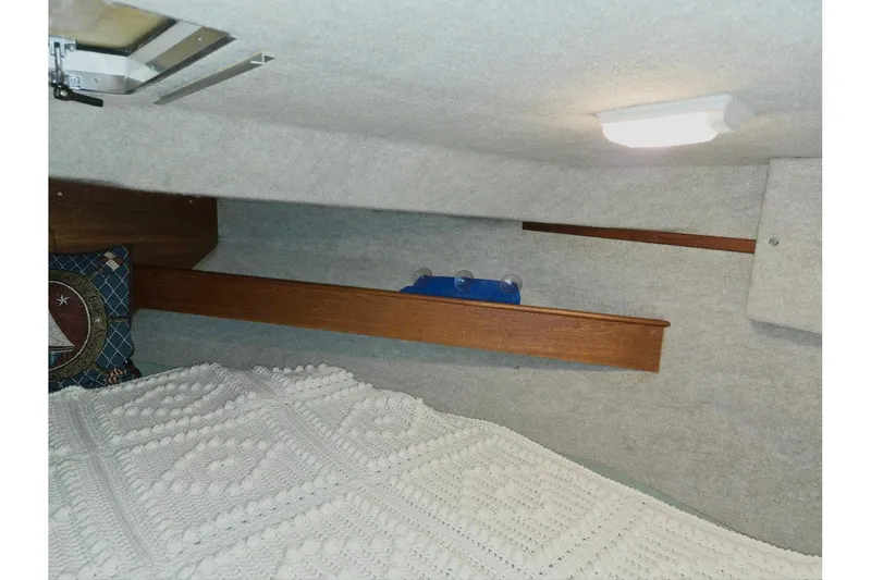 Slide: The Image of 2001 Commander Flybridge Sedan cabin interior with cozy bedding and nautical decor. - 91