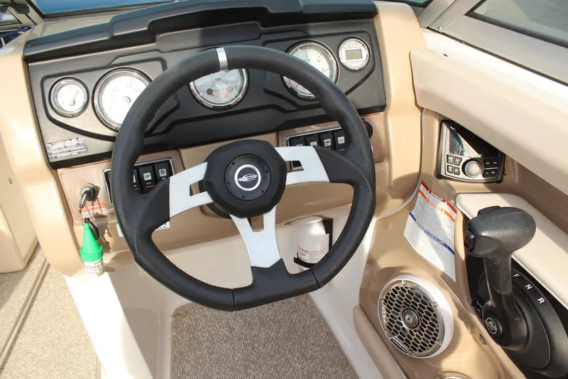 Slide: The Image of 2011 Chaparral 216 SSi boat dashboard with steering wheel and control panel. - 13