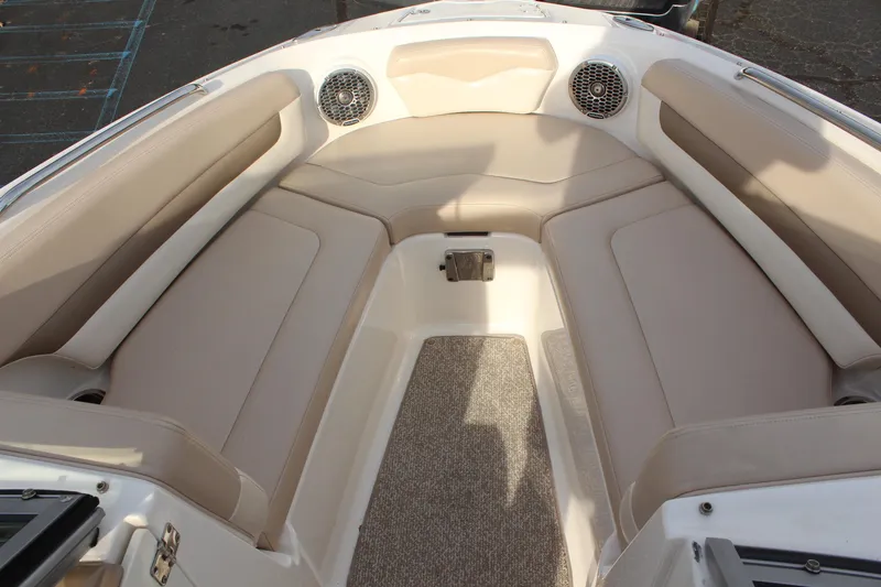 Slide: The Image of 2011 Chaparral 216 SSi boat interior with beige seating and speakers. - 16
