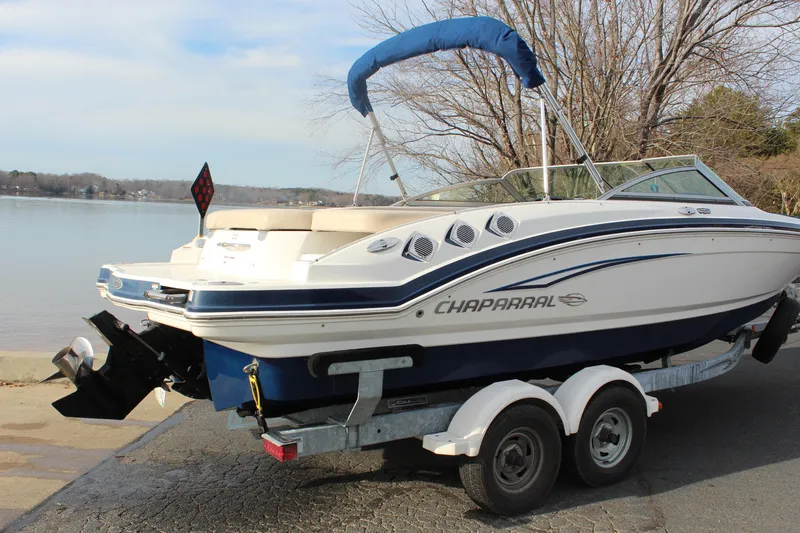 Slide: The Image of 2011 Chaparral 216 SSi boat on trailer by a lake, ready for launch. - 3