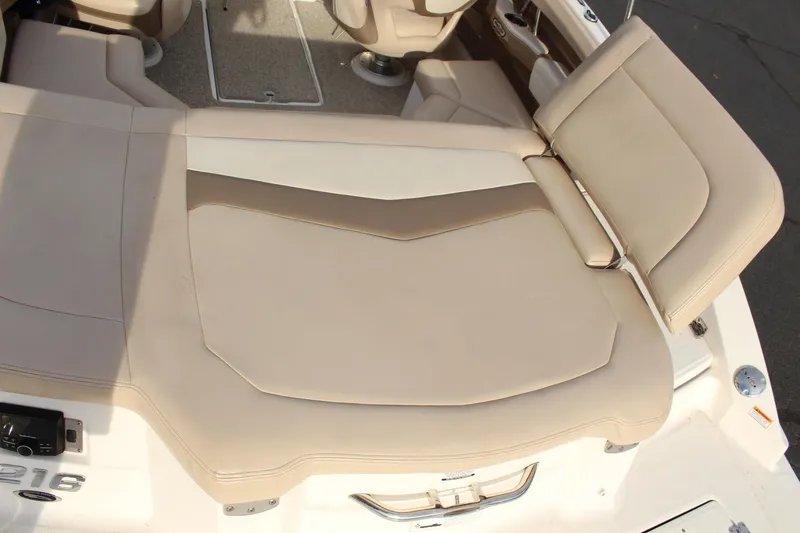 Slide: The Image of 2011 Chaparral 216 SSi boat interior with beige seating and deck layout. - 6