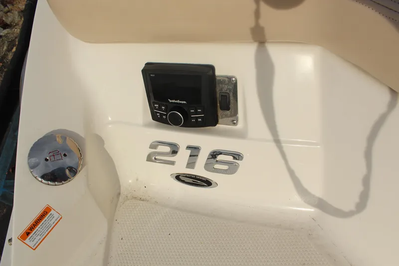 Slide: The Image of 2011 Chaparral 216 SSi boat dashboard with stereo and model emblem. - 7