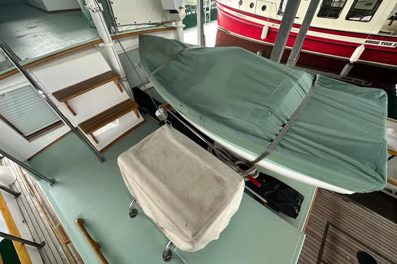 Slide: The Image of 1973 Grand Banks 36 Classic yacht deck with covered equipment and wooden steps. - 19