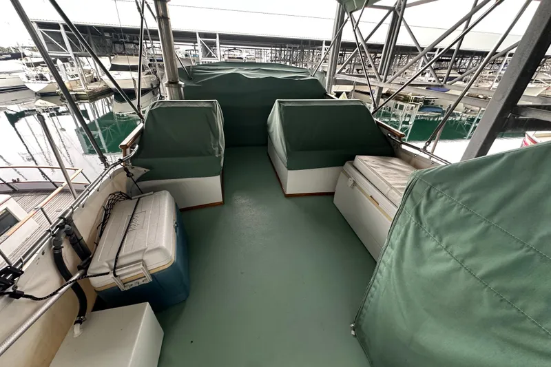 Slide: The Image of 1973 Grand Banks 36 Classic boat deck with green covers and marina view. - 20