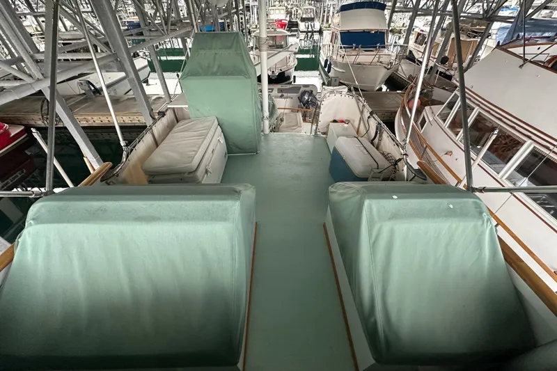 Slide: The Image of 1973 Grand Banks 36 Classic yacht docked in a marina, featuring covered seating. - 21