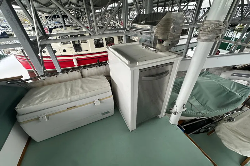 Slide: The Image of 1973 Grand Banks 36 Classic boat deck with seating and grill under marina cover. - 22