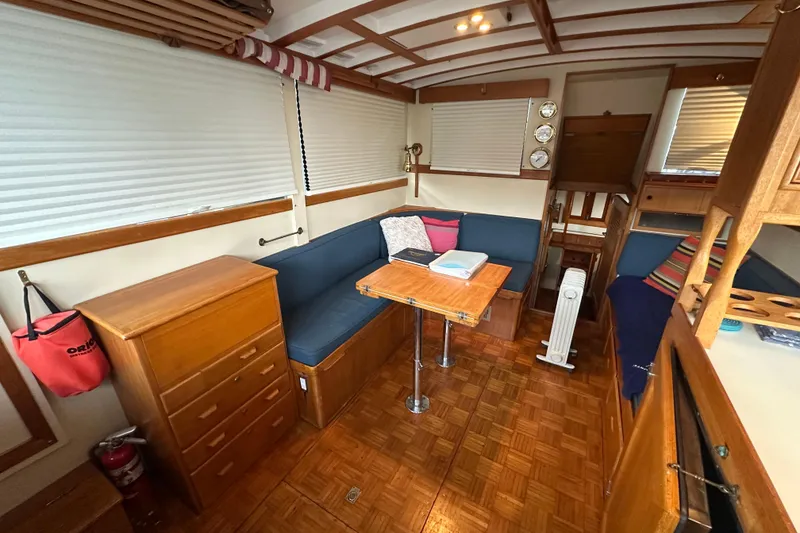 Slide: The Image of 1973 Grand Banks 36 Classic yacht interior with wood furnishings and cozy seating area. - 27