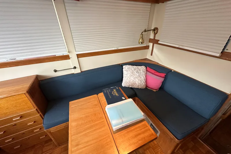 Slide: The Image of Interior of 1973 Grand Banks 36 Classic with blue seating and wooden table. - 29