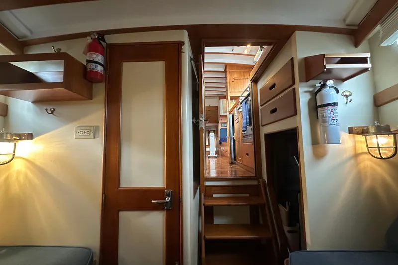 Slide: The Image of Interior of a 1973 Grand Banks 36 Classic yacht, featuring wooden cabinetry and safety equipment. - 33