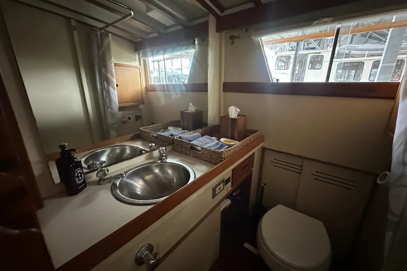 Slide: The Image of 1973 Grand Banks 36 Classic yacht bathroom with dual sinks and window view. - 39