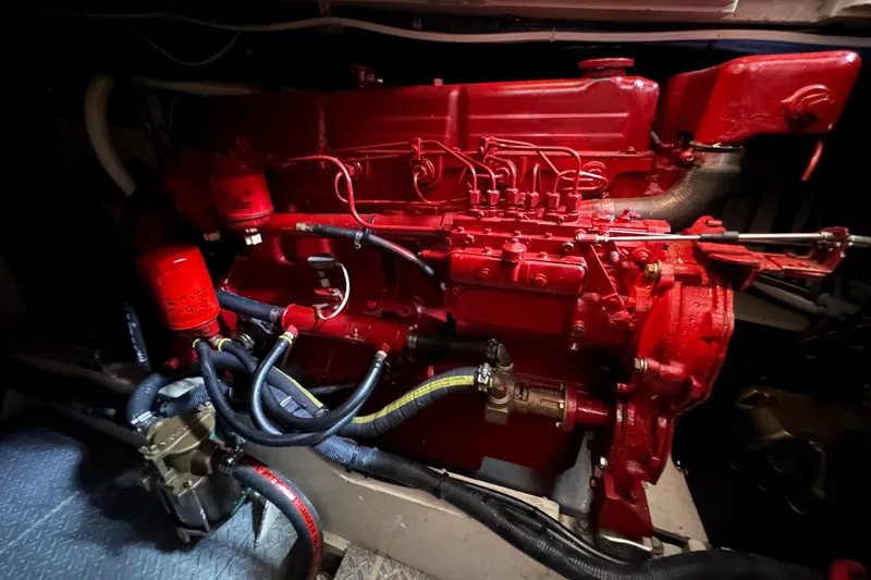 Slide: The Image of Engine of a 1973 Grand Banks 36 Classic boat, painted in vibrant red. - 42
