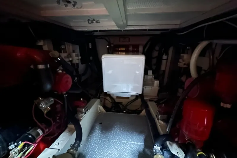 Slide: The Image of Engine room of a 1973 Grand Banks 36 Classic boat, featuring mechanical components and wiring. - 44