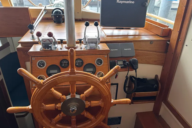 Slide: The Image of 1973 Grand Banks 36 Classic helm with wooden wheel and Raymarine navigation system. - 6