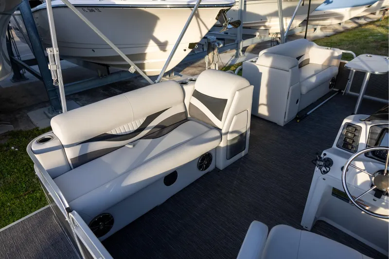 Slide: The Image of 2022 Qwest Lanai 818 pontoon boat interior with modern seating and steering console. - 5