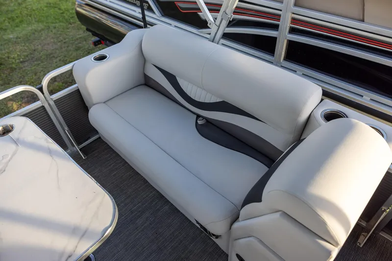 Slide: The Image of 2022 Qwest Lanai 818 boat interior with gray seating and cup holders. - 9
