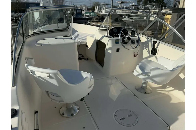 Slide: The Image of 2002 Sea Hunt Escape 175 boat interior with steering wheel and seating. - 11