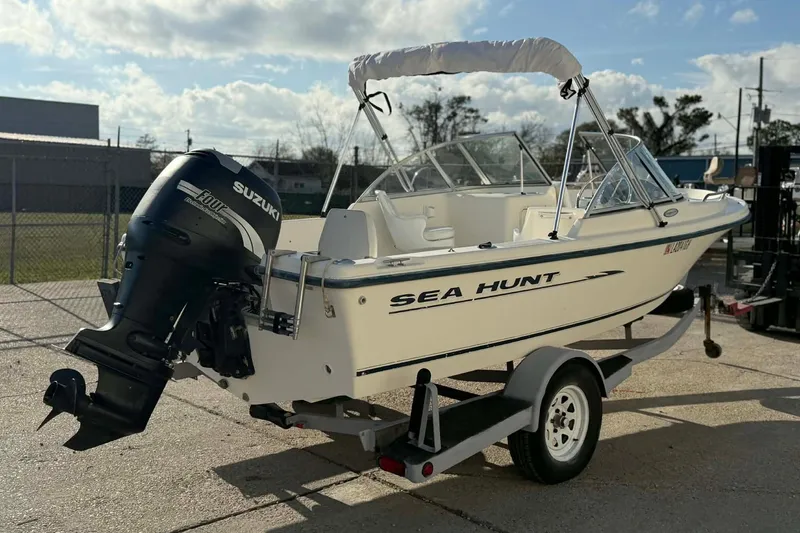 Slide: The Image of 2002 Sea Hunt Escape 175 boat with Suzuki outboard motor on trailer. - 6