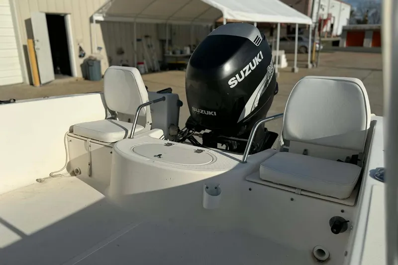 Slide: The Image of 2002 Sea Hunt Escape 175 boat interior with Suzuki outboard motor and seating. - 7