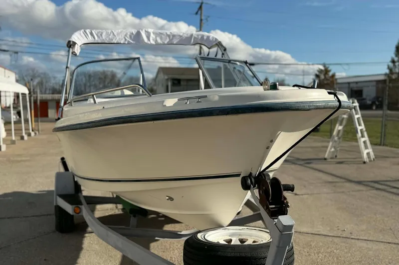 Slide: The Image of 2002 Sea Hunt Escape 175 boat on trailer under clear sky. - 8