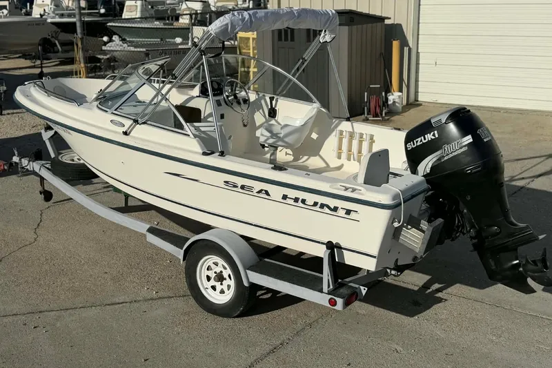 Slide: The Image of 2002 Sea Hunt Escape 175 boat on trailer with Suzuki outboard motor. - 9
