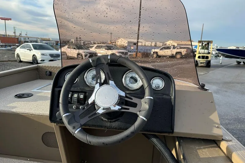 Slide: The Image of 2023 SMOKERCRAFT 1660 SPORTSMAN PRO SC boat dashboard with steering wheel and gauges. - 4